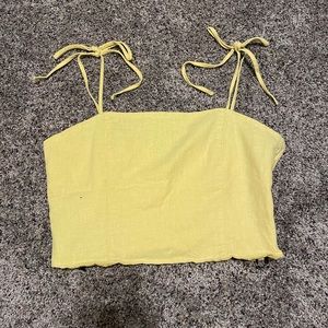 Yellow crop top with adjustable straps.